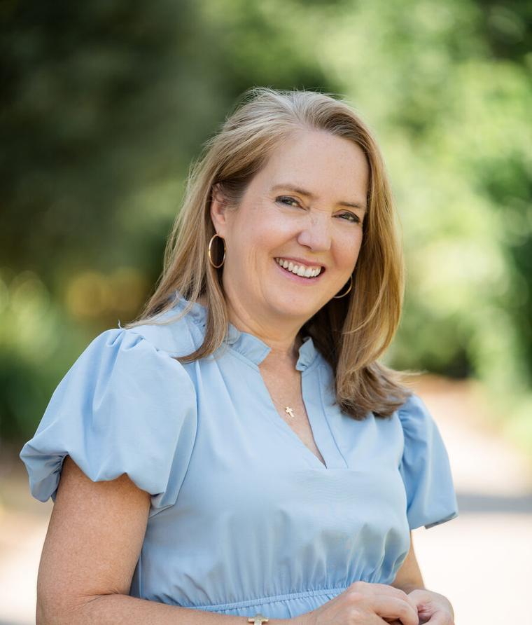 Barbara Burgess, LCMHCA, smiling outdoors in a light blue blouse